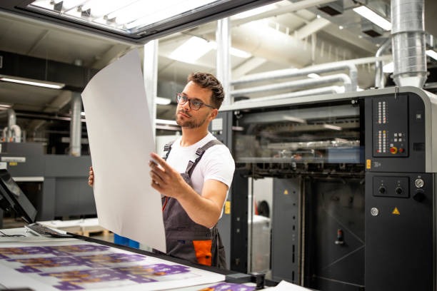 Press operator inspecting print production